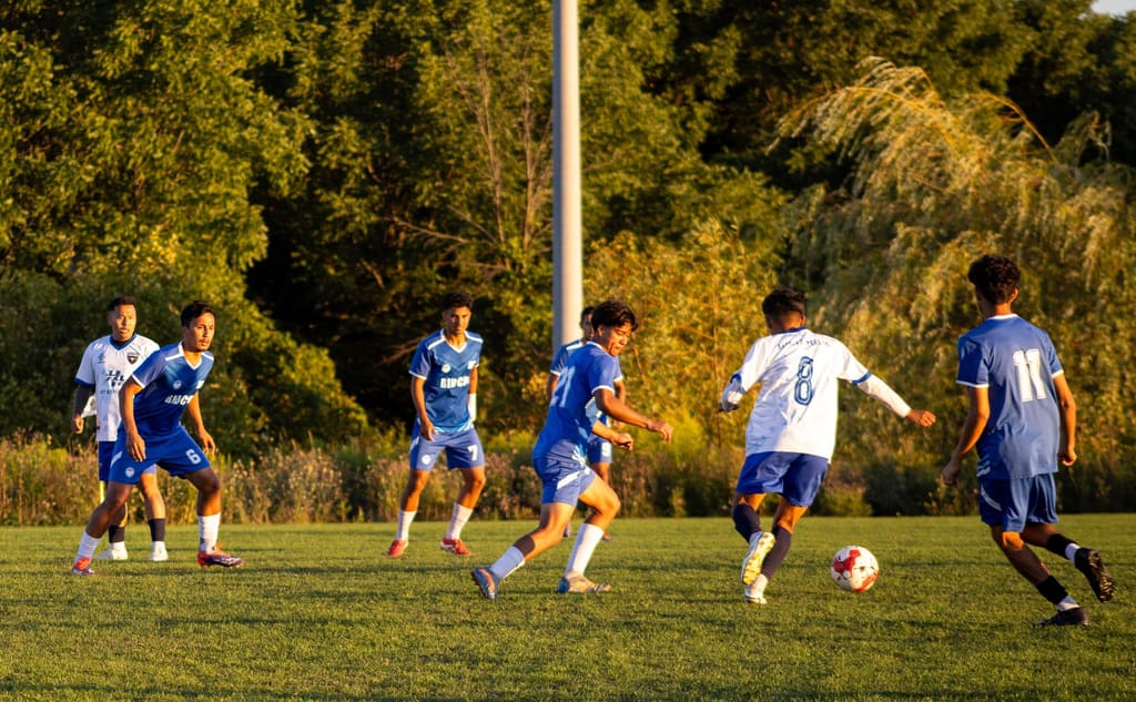 Nepal Cup players competing during a daytime match.
